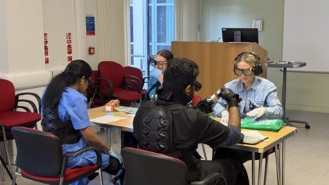 student trying on a frailty suit