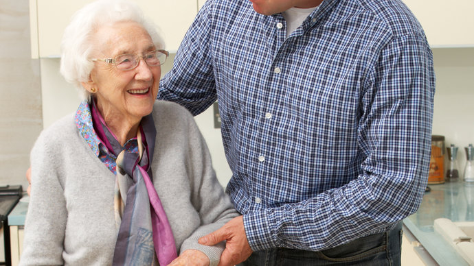 Male carer with older woman