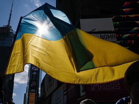 Ukrainian flag with sun shining through it